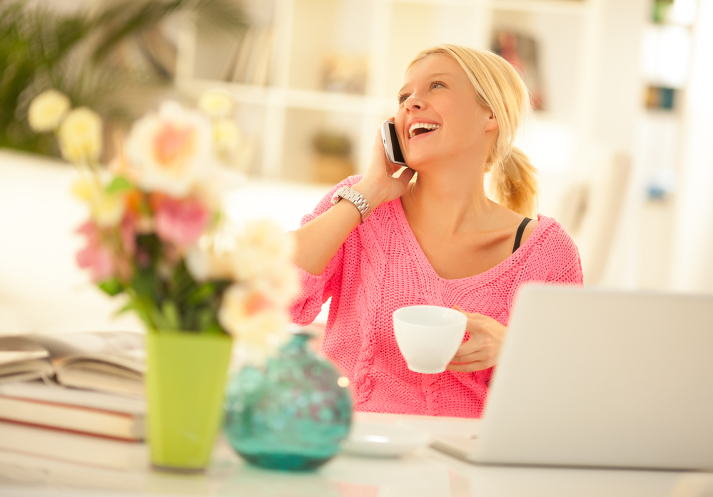 Mid-adult woman making a phone call at home.